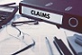 Claims - Ring Binder on Office Desktop with Office Supplies-1